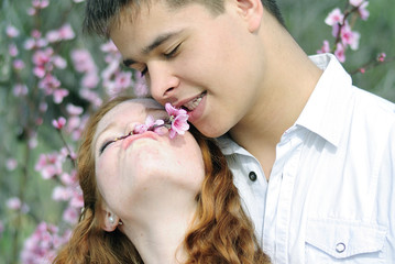 Obraz premium beautiful young couple in love among the flowering trees