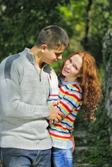 Fototapeta premium Young beautiful couple in park