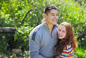 Fototapeta premium Young beautiful couple in park