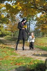 Fototapeta premium little boy with his mother in autumn park