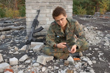 Teenager, boy in battle dress, of knife and rifle, Air Soft Gun