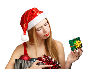 Young woman in santa hat with christmas attributes and little gi