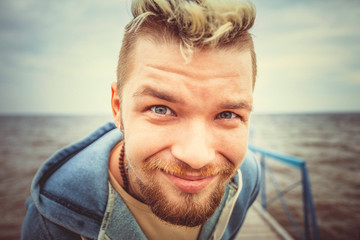 Fototapeta premium Young handsome man portrait fisheye caricature