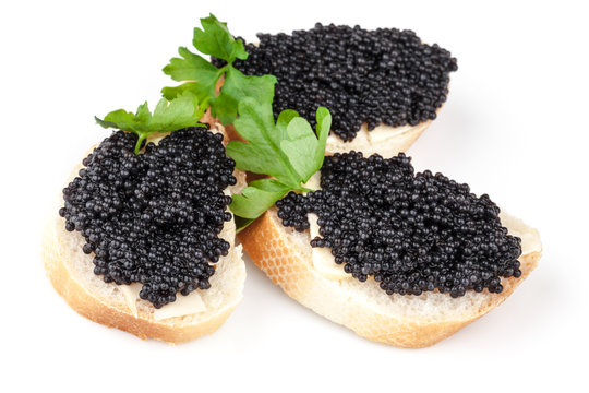 Three sandwiches with black caviar isolated on white background