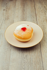 Donut for jewish holiday hanukkah on wooden background
