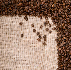 Coffee beans on burlap background