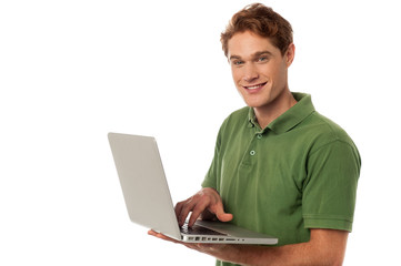 Handsome guy operating laptop