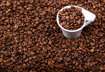 Cup of coffee filled with coffee beans