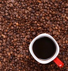 Cup of coffee on coffee beans background