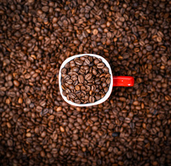 Cup of coffee on coffee beans background