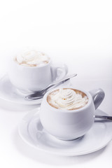 Coffee and whipped cream on white background