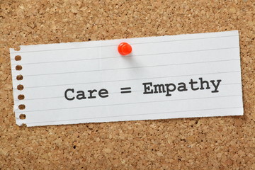 Care equals Empathy on a cork notice board