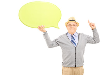 Senior gentleman holding a speech bubble and gesturing