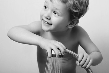 smiling little boy in the shower.Bath.child.monochrome © eugenepartyzan