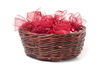 Red christmas bows in wicker basket