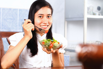 Woman eating salad