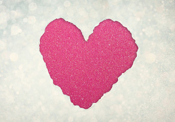heart shape made from torn paper over glitter boke soft lights