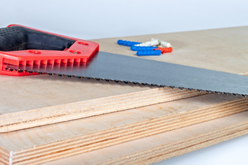 hacksaw on plywood boards with dowels