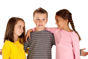 two young girls looking at a young boy