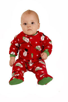 Toddler Boy Sitting In Red Snowman Pajamas