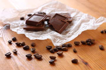 chocolate, cinamon and coffee beans on wooden table