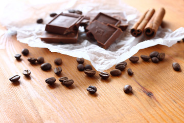 chocolate, cinamon and coffee beans on wooden table