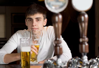 Aluminium Prints Bar Young man drinking alone