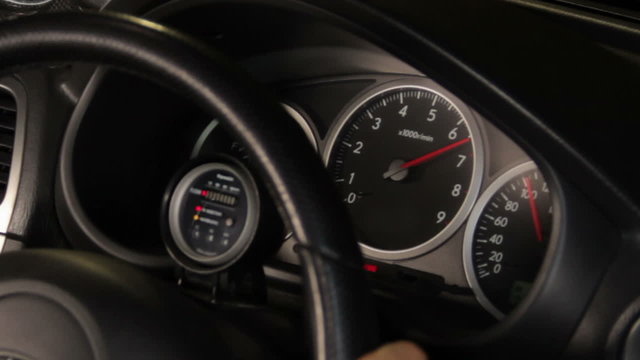 Car speedometer revving red line