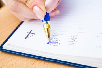 Business Woman Writing with pen in notepad