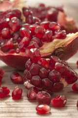 Fresh and juicy pomegranate fruit on wood