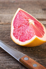 slice of grapefruit and knife