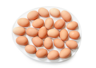 Lot of brown eggs in a row on a tray.