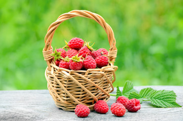 Fototapeta na wymiar Fresh ripe raspberries in the wicker basket