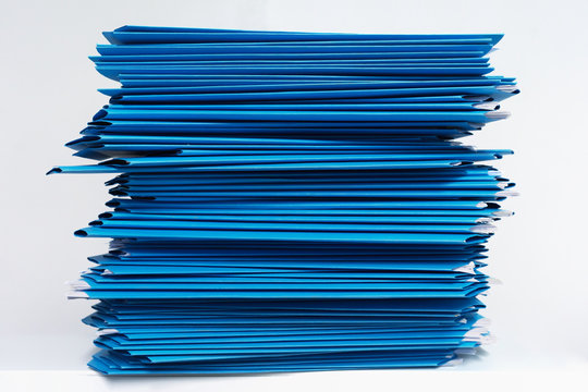 Stacks Of Blue Folders Over White Background