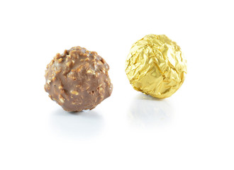 Sweet chocolate candy wrapped in golden foil isolated on white b