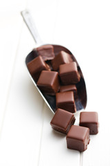 chocolate pralines on metal scoop