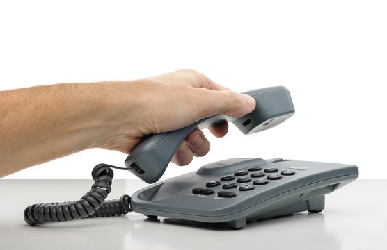 Phone Call: a man's hand hanging the phone receiver