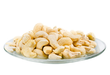 Saucer with a row cashew nuts isolated on white background