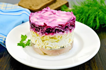 Herring with vegetables in white plate