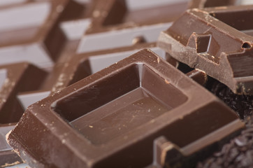 Closeup detail of chocolate parts on white background.