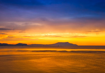 golden sunset on the sea and mountain view