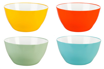 Colored plastic bowls on white background