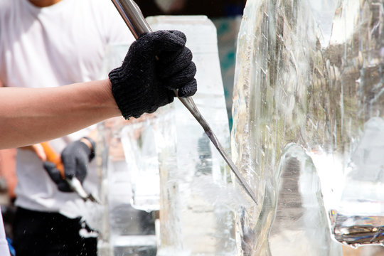 Ice Sculpting,Ice Carver Using Chisel to Carve