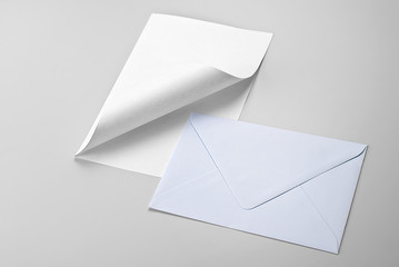 Sheet of paper with curled corner and envelope