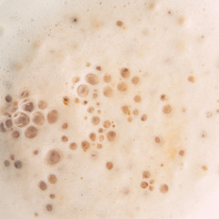 Milk foam in the coffee as a background