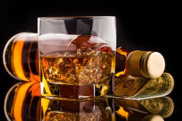 money and whisky bottle
