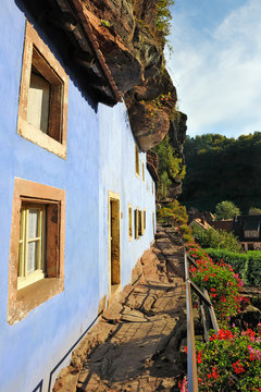 The blue troglodyte houses in rock face at Graufthal