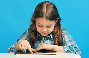 Caucasian little girl on a blue background