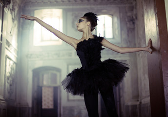 Black swan ballet dancer in move