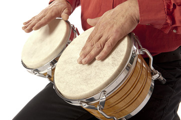 Man playing bongo set on his lap